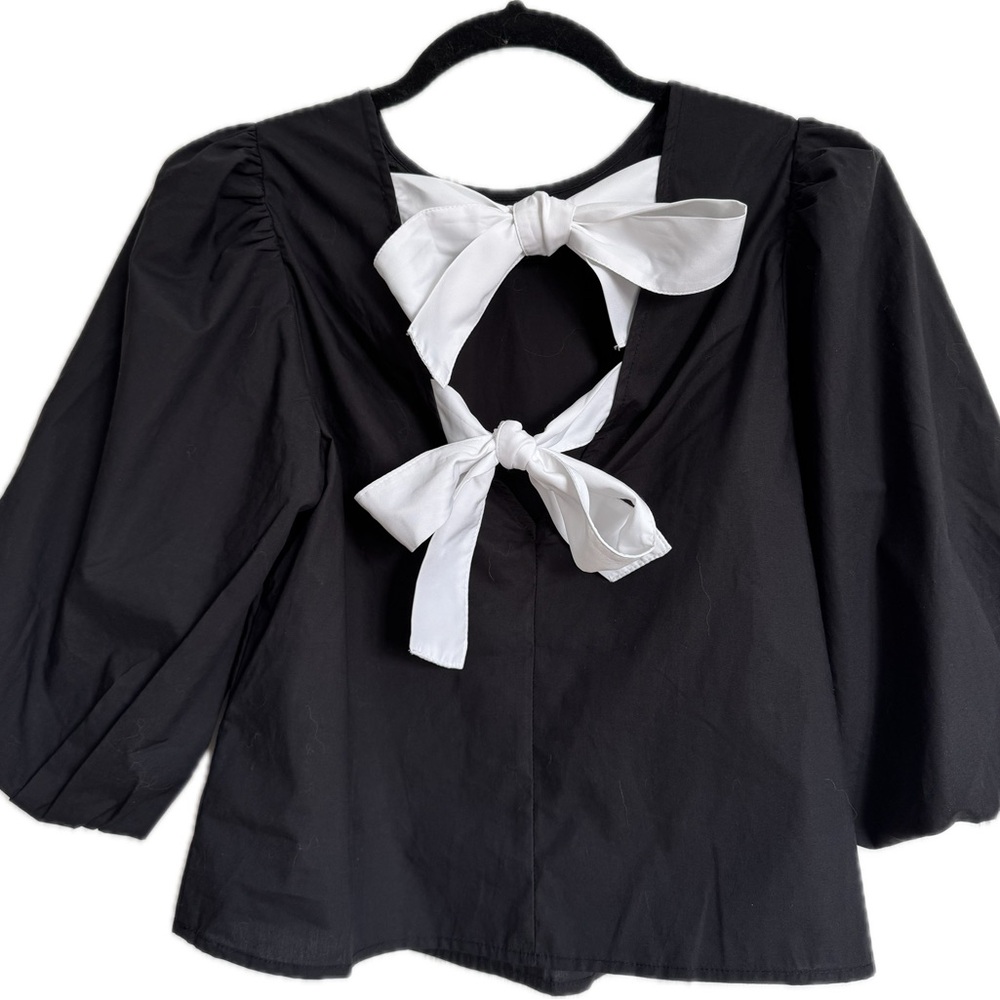 Elegant Black Top with White Bow Accents